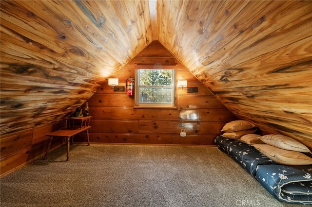 bonus room with wooden ceiling, carpet flooring, vaulted ceiling, and wooden walls