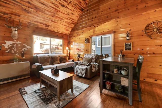 living room with wooden walls, lofted ceiling, and wood-type flooring
