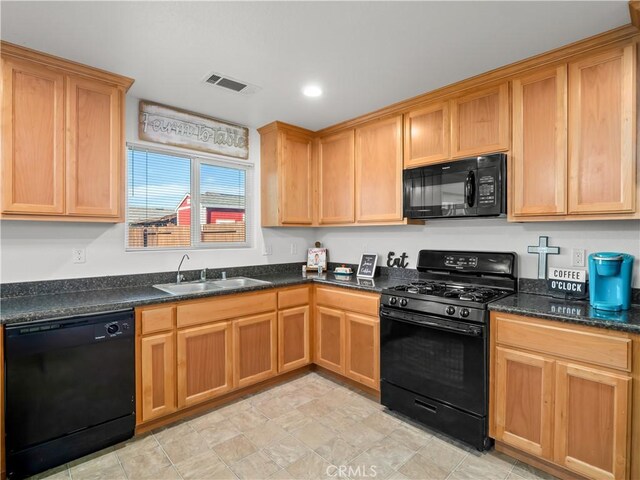 kitchen with recessed lighting, a sink, visible vents, black appliances, and dark stone countertops