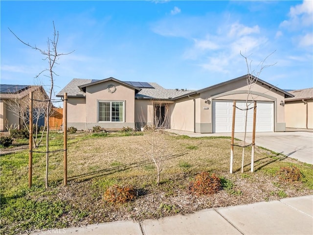 ranch-style home with solar panels, stucco siding, a front yard, a garage, and driveway