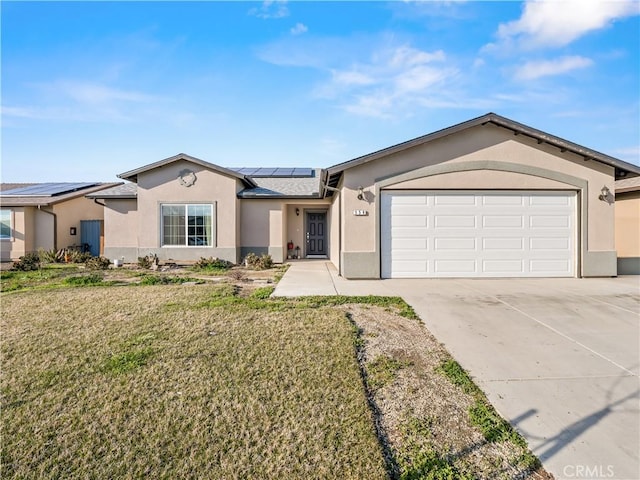 ranch-style home featuring a garage, solar panels, a front lawn, and stucco siding