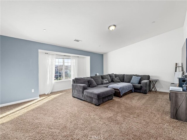 carpeted living area with visible vents and baseboards