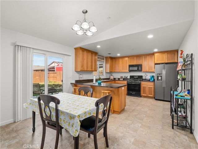 kitchen with lofted ceiling, recessed lighting, a peninsula, black appliances, and dark countertops