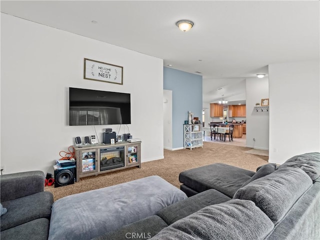 living room with lofted ceiling, baseboards, and carpet flooring