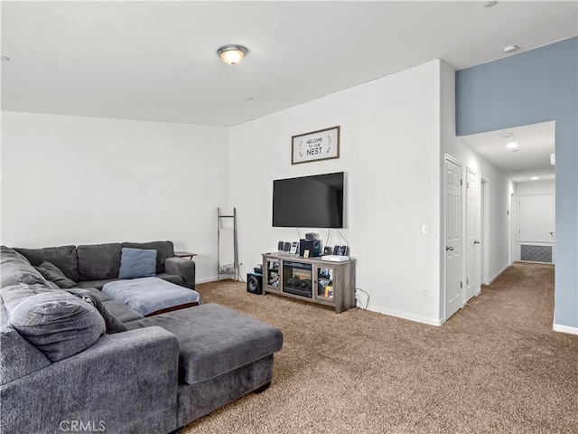 living area featuring visible vents, baseboards, and carpet flooring