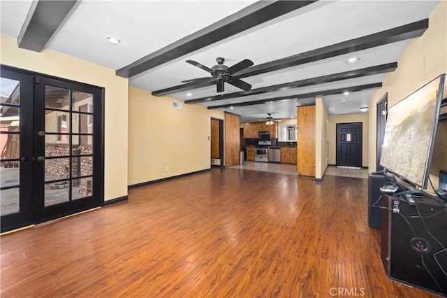 unfurnished living room featuring beam ceiling, baseboards, dark wood-style flooring, and french doors