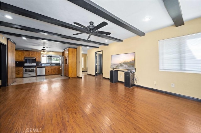 unfurnished living room with dark wood-style floors, ceiling fan, baseboards, and beamed ceiling