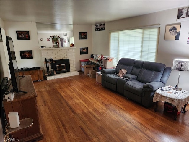 living room with a fireplace and wood finished floors