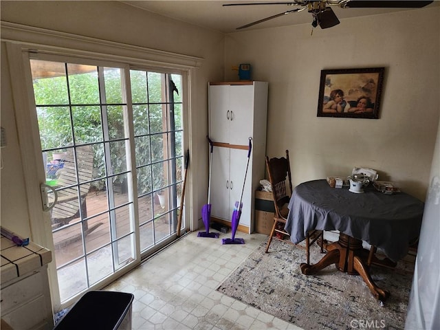 dining area with a ceiling fan and light floors