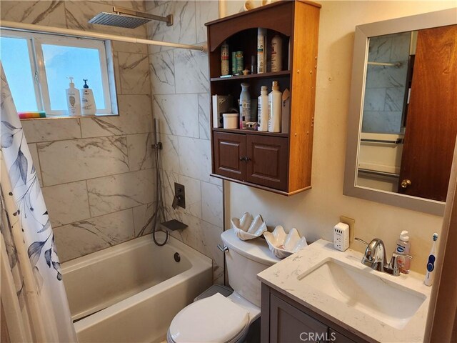 bathroom with toilet, vanity, and shower / tub combo with curtain