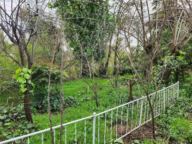 exterior space featuring fence and a view of trees