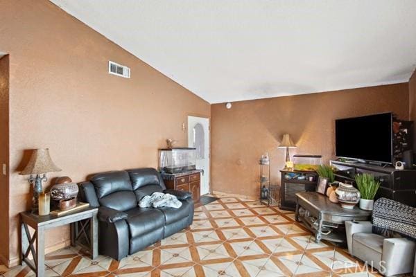 living room with visible vents and lofted ceiling