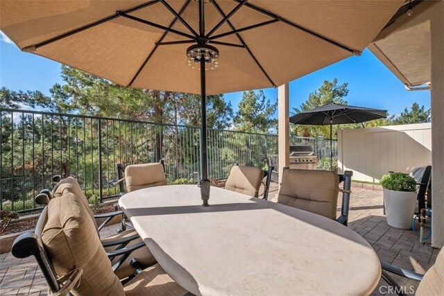 view of patio with outdoor dining area and fence