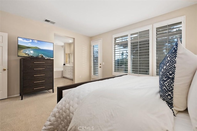 bedroom featuring carpet floors, visible vents, ensuite bath, access to outside, and baseboards