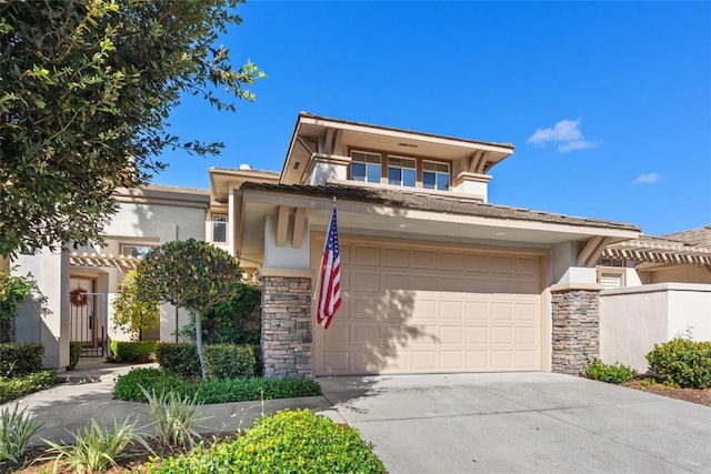 view of front facade featuring an attached garage, driveway, stone siding, and stucco siding