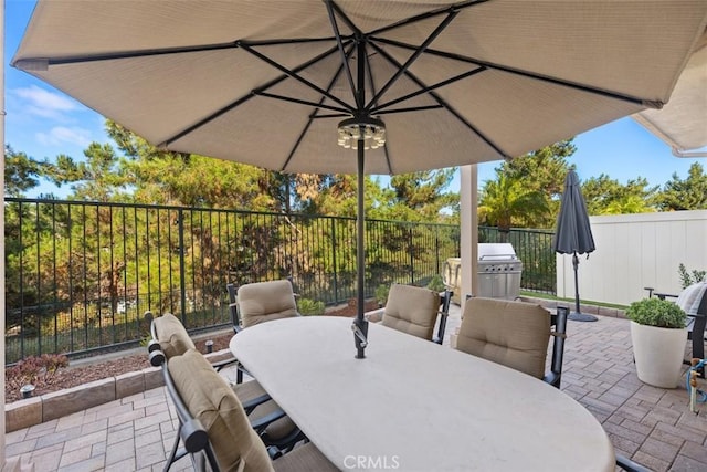 view of patio / terrace with outdoor dining area, fence, and area for grilling