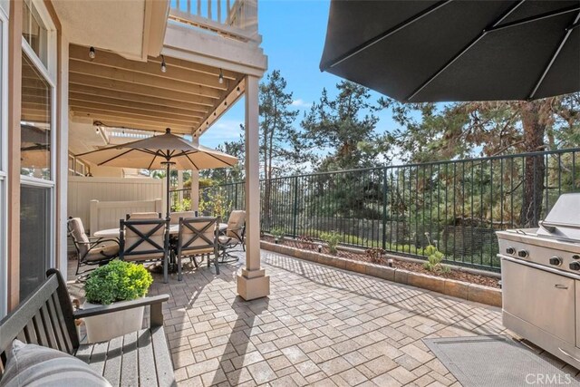 view of patio / terrace featuring outdoor dining space, grilling area, and a fenced backyard