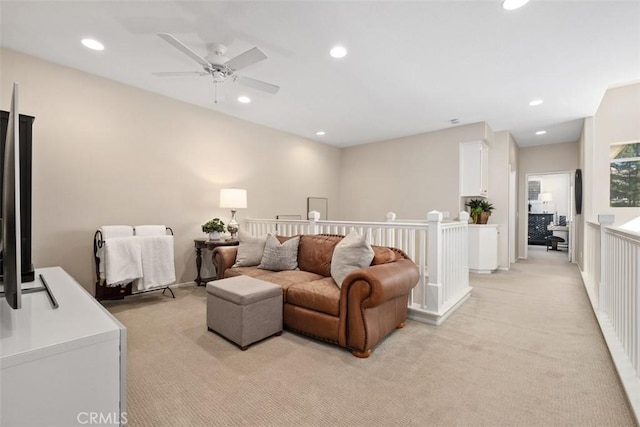 living room featuring light carpet, ceiling fan, and recessed lighting