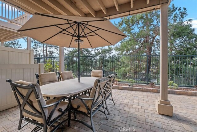 view of patio with fence and outdoor dining space