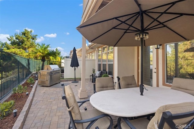 view of patio / terrace featuring outdoor dining area, grilling area, and a fenced backyard