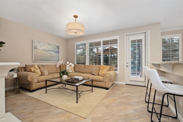 living area with light wood-style floors and baseboards