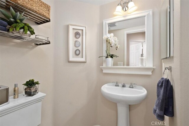 bathroom featuring visible vents and toilet