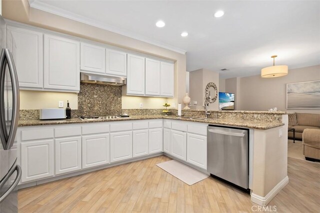 kitchen with under cabinet range hood, stainless steel appliances, a peninsula, white cabinetry, and light wood finished floors