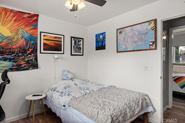 bedroom featuring a ceiling fan, wood finished floors, and baseboards