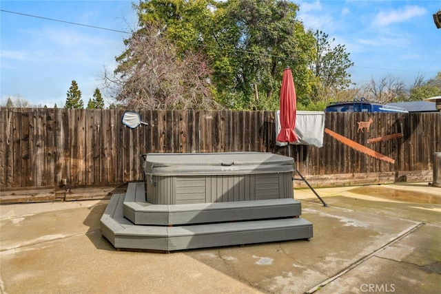 details featuring a fenced backyard and a hot tub