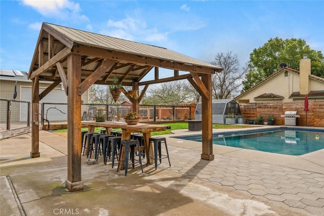 view of swimming pool with a gazebo, area for grilling, a fenced backyard, and a patio area