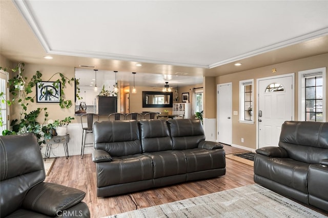 living area with plenty of natural light, wood finished floors, recessed lighting, and baseboards