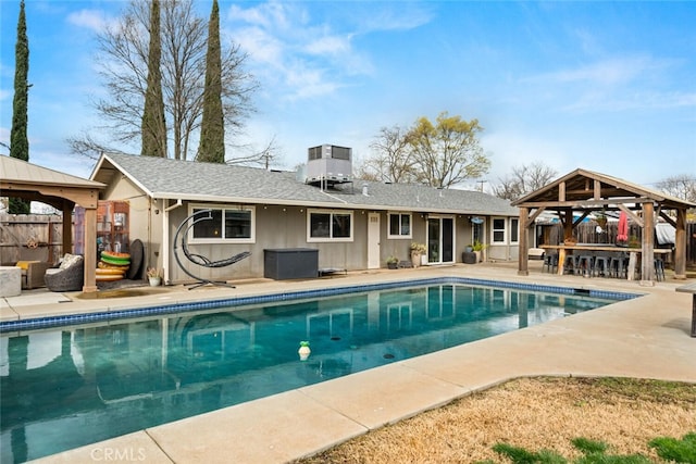 view of pool with a gazebo, central AC, and a patio