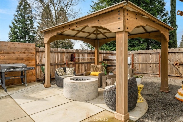 view of patio / terrace with a gazebo, area for grilling, a fenced backyard, and an outdoor fire pit