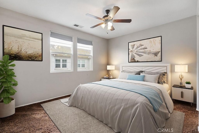 bedroom with carpet floors, baseboards, visible vents, and ceiling fan