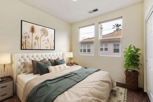 carpeted bedroom featuring visible vents