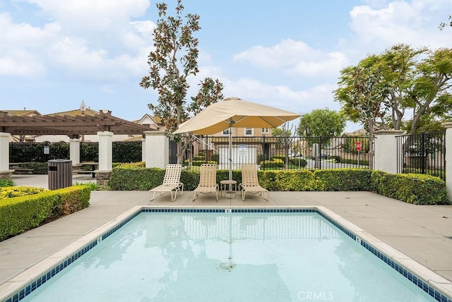 pool featuring fence and a pergola