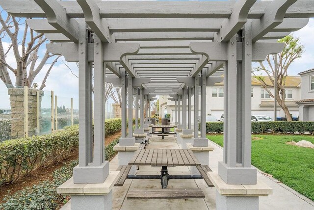 view of property's community with a patio area, a pergola, and a yard