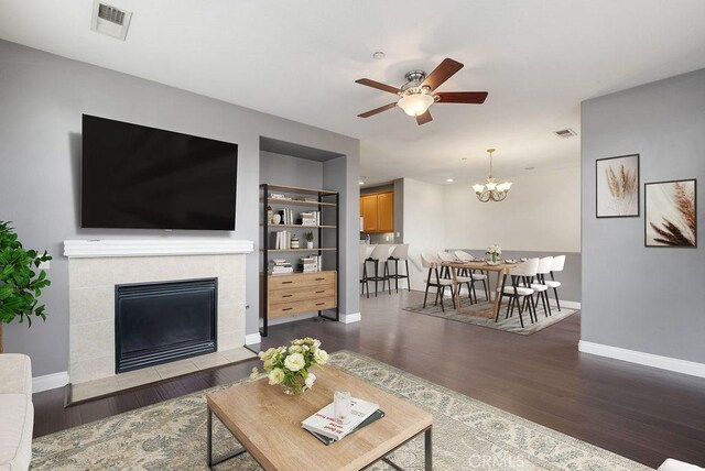 living room featuring visible vents, dark wood finished floors, and baseboards