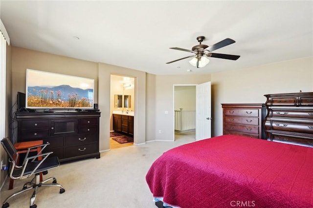 bedroom with baseboards, light carpet, ceiling fan, and ensuite bathroom