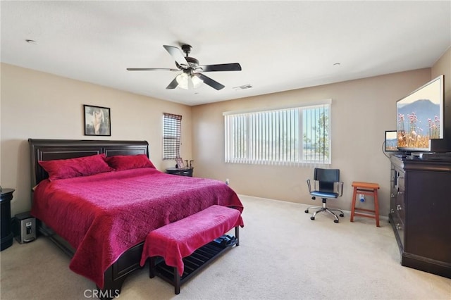 carpeted bedroom featuring visible vents, baseboards, and a ceiling fan