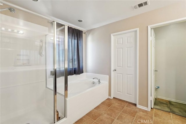 bathroom featuring tile patterned floors, visible vents, a stall shower, baseboards, and a bath