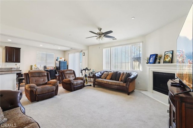 living area with visible vents, a fireplace, recessed lighting, ceiling fan, and light colored carpet