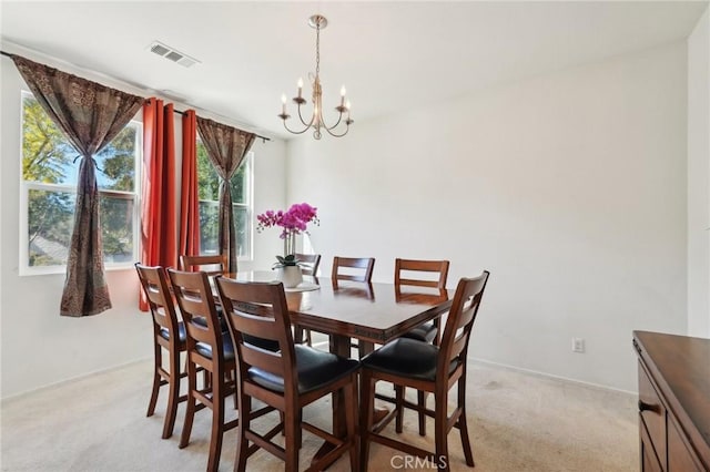 dining area with baseboards, visible vents, a chandelier, and light carpet