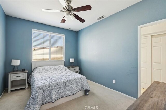 bedroom with visible vents, baseboards, carpet, and ceiling fan