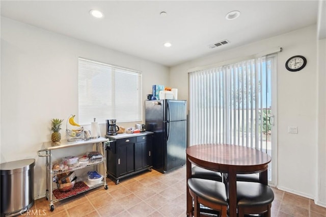 kitchen with visible vents, freestanding refrigerator, recessed lighting, light countertops, and baseboards