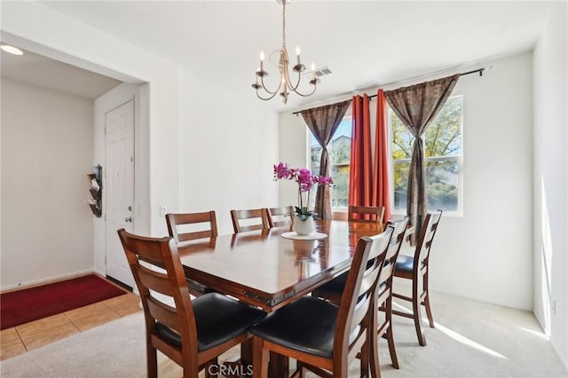 dining space featuring light tile patterned flooring, visible vents, light colored carpet, and a chandelier