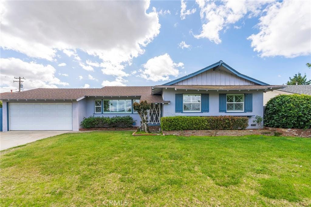 single story home featuring an attached garage, stucco siding, concrete driveway, and a front yard