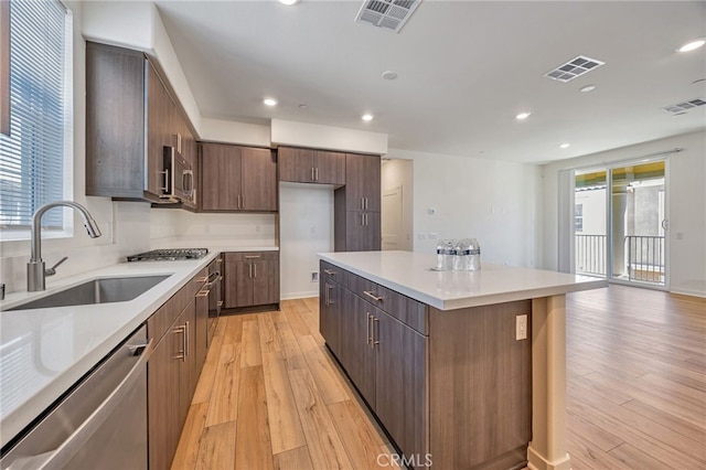 kitchen with a sink, appliances with stainless steel finishes, a wealth of natural light, and visible vents