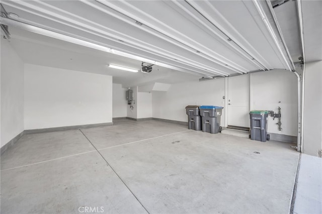 garage with a garage door opener and baseboards