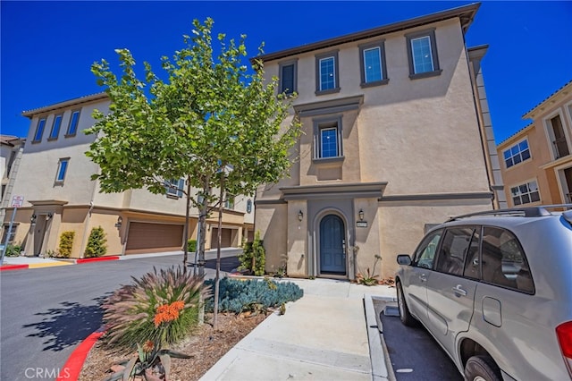 townhome / multi-family property featuring stucco siding and an attached garage
